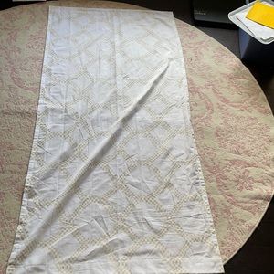 two pair long gold and white curtains